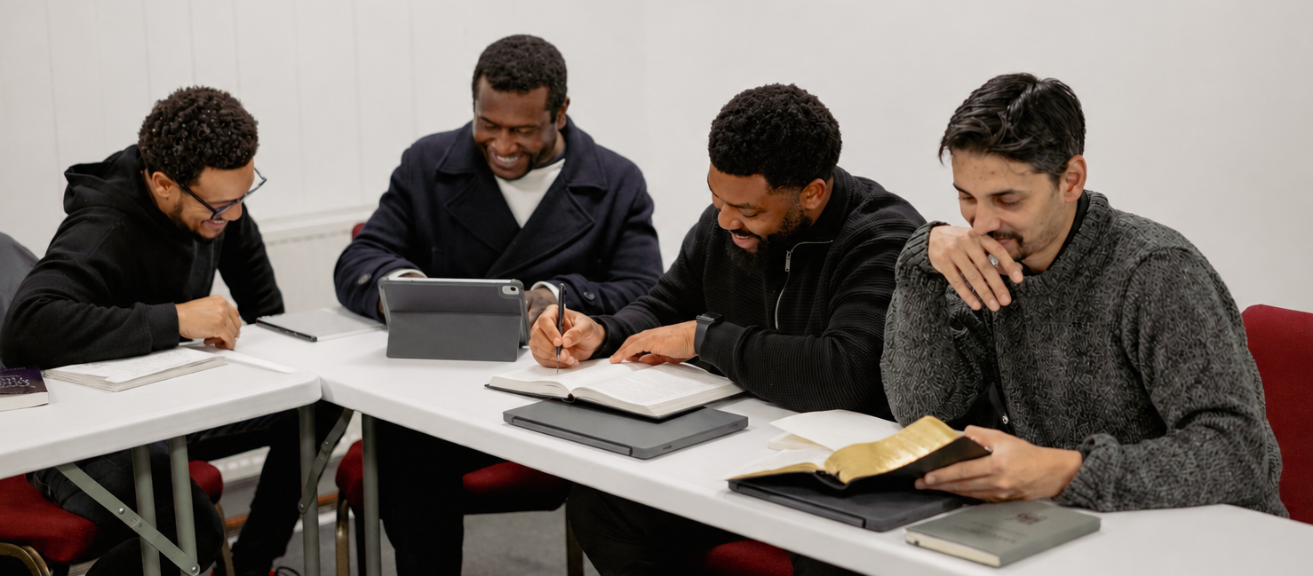 Hermeneia Diploma in Expository Preaching students siting around a table at lunch with a lecturer